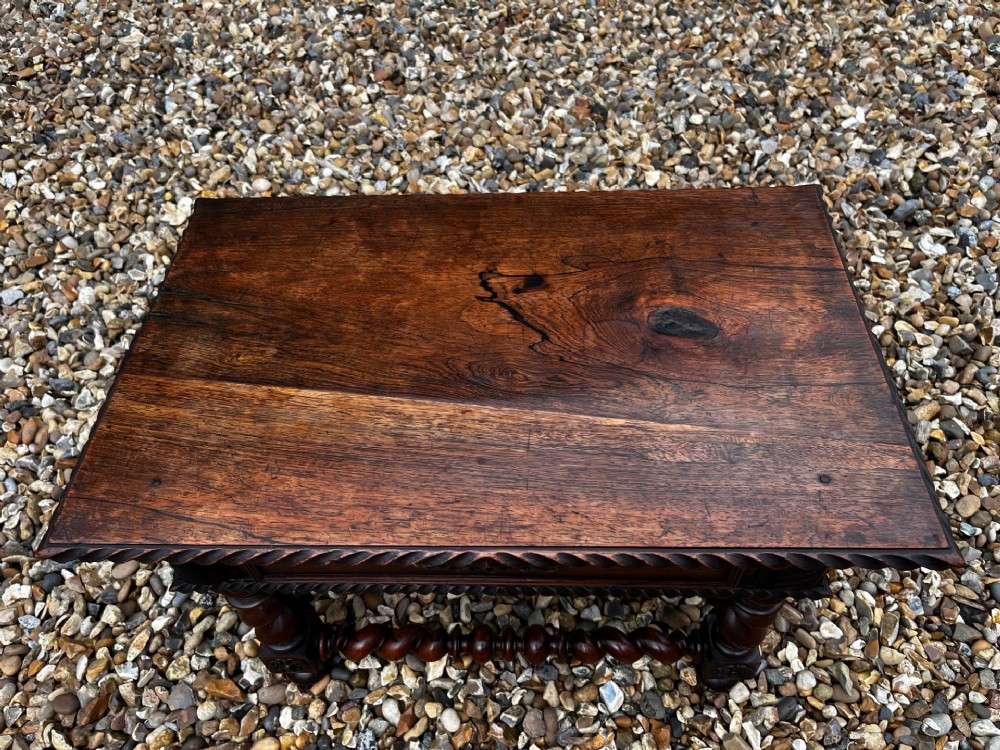 An early 19th-century Portuguese dark rosewood low table featuring spiral barley twist legs, carved rope moulding, and a single drawer with a brass keyhole escutcheon. View III