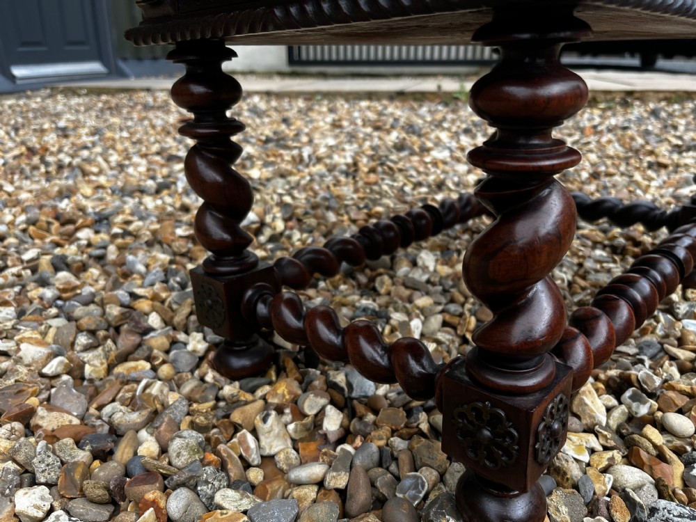 An early 19th-century Portuguese dark rosewood low table featuring spiral barley twist legs, carved rope moulding, and a single drawer with a brass keyhole escutcheon. View VII