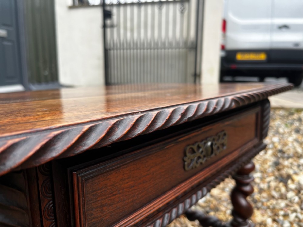 An early 19th-century Portuguese dark rosewood low table featuring spiral barley twist legs, carved rope moulding, and a single drawer with a brass keyhole escutcheon. View VIII