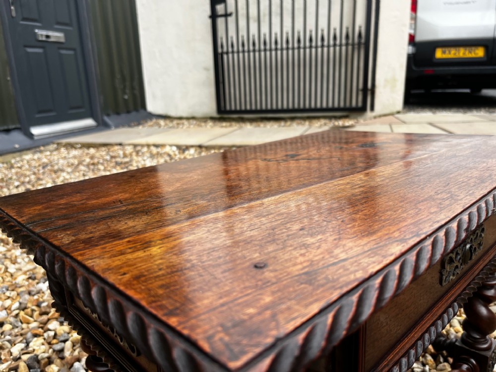 An early 19th-century Portuguese dark rosewood low table featuring spiral barley twist legs, carved rope moulding, and a single drawer with a brass keyhole escutcheon. View IX