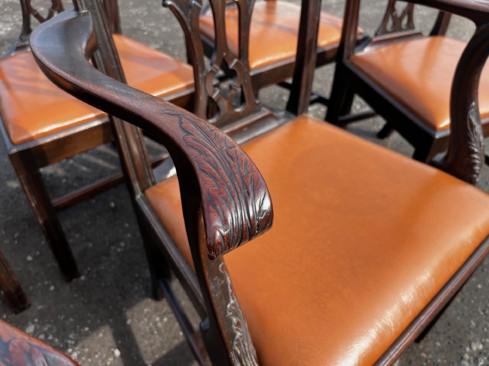 A set of late nineteenth-century mahogany Chippendale style dining chairs featuring intricately carved back splats and tan leather upholstered seats. View II