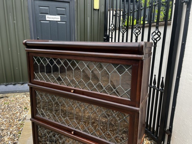 A three-tier Edwardian solid mahogany Globe Wernicke stacking bookcase featuring diamond-leaded glazed doors and a plinth base. View III