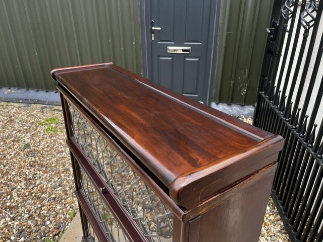 A three-tier Edwardian solid mahogany Globe Wernicke stacking bookcase featuring diamond-leaded glazed doors and a plinth base. View V