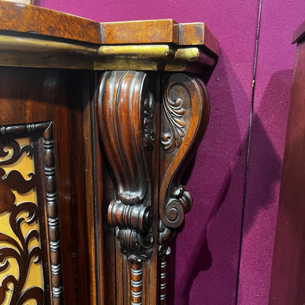 An early Victorian Goncalo Alves and amboyna low bookcase credenza featuring glazed doors and carved corbels. View III