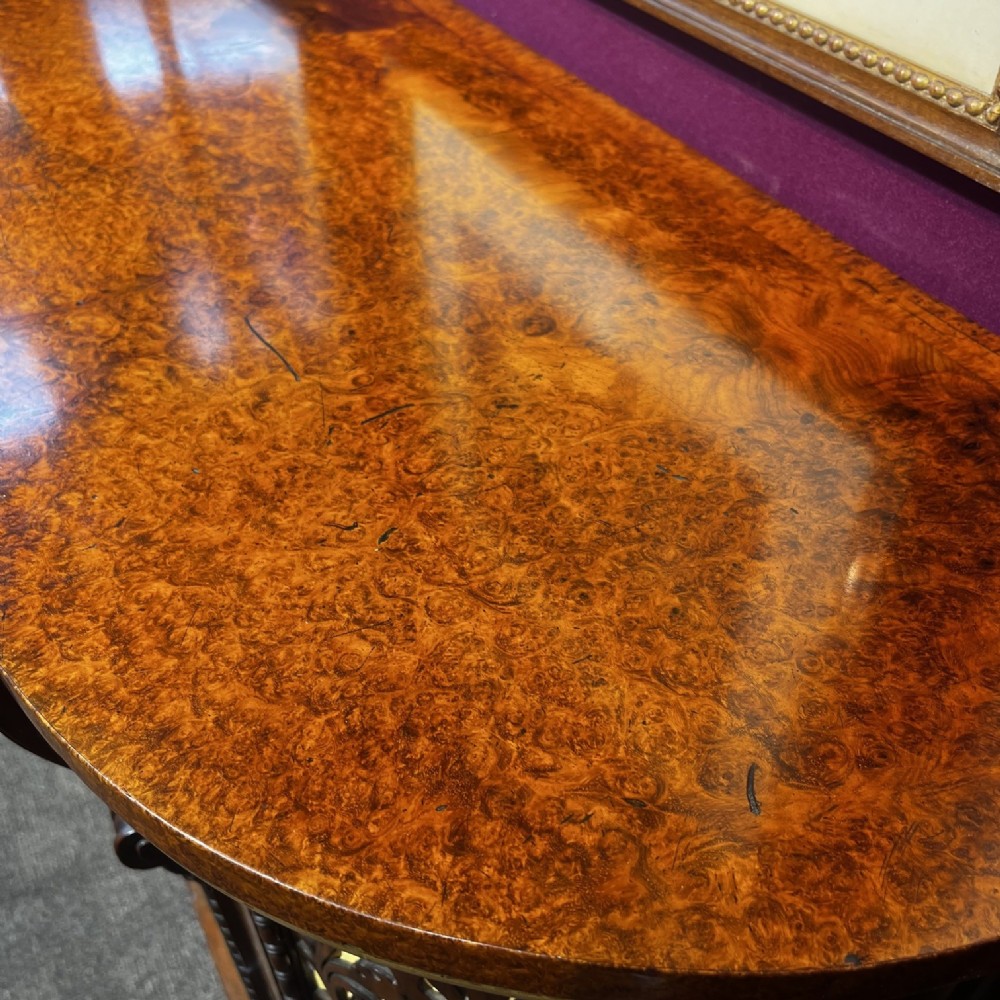 An early Victorian Goncalo Alves and amboyna low bookcase credenza featuring glazed doors and carved corbels. View VI