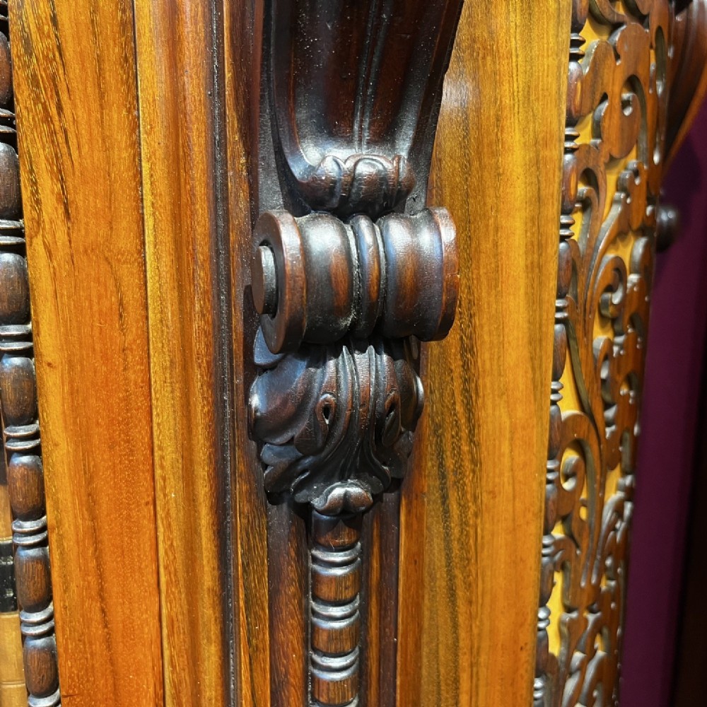 An early Victorian Goncalo Alves and amboyna low bookcase credenza featuring glazed doors and carved corbels. View XII