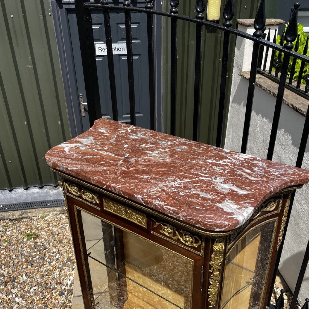 A French Louis XV style mahogany display cabinet featuring glazed sides, gilt bronze mounts, a marble top, and a lower hand-painted Vernis Martin panel. View VII