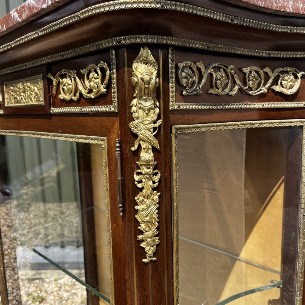 A French Louis XV style mahogany display cabinet featuring glazed sides, gilt bronze mounts, a marble top, and a lower hand-painted Vernis Martin panel. View IX