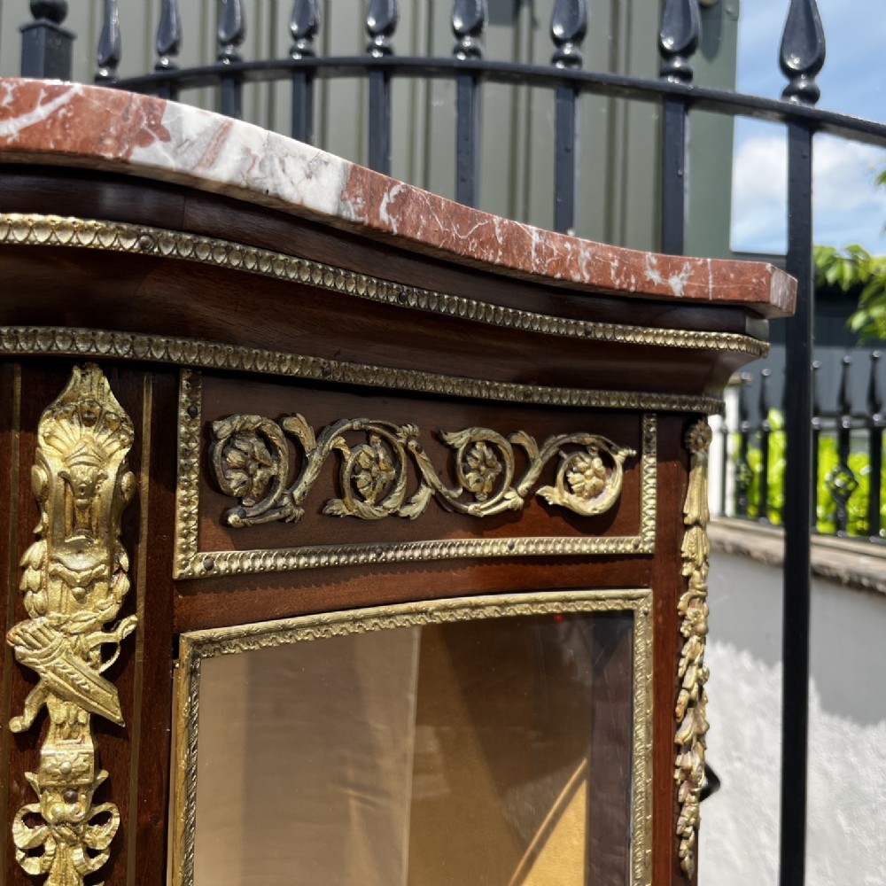 A French Louis XV style mahogany display cabinet featuring glazed sides, gilt bronze mounts, a marble top, and a lower hand-painted Vernis Martin panel. View X