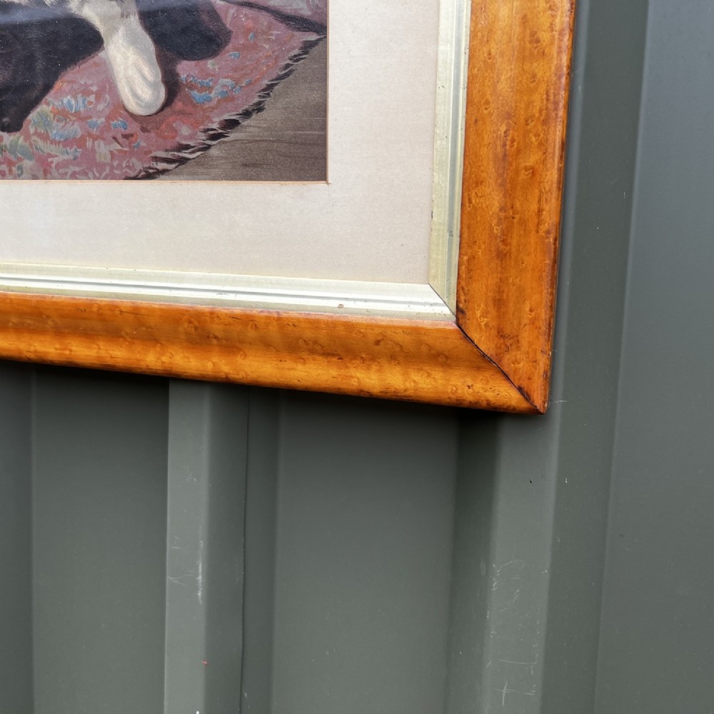 A framed nineteenth-century chromolithograph depicting a mother cat and four kittens resting on a rug, set within a timber frame with a gilt inner slip. View III