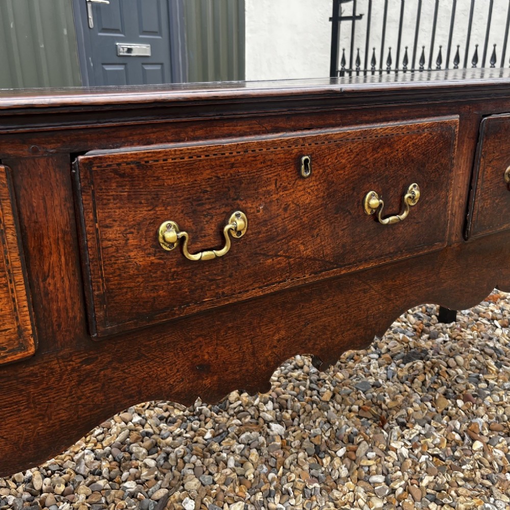 A George III Period Oak Three Drawer Dresser Base. View V