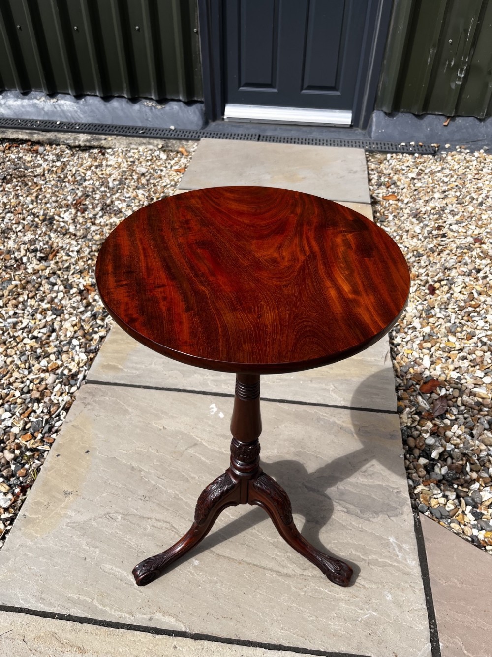 A 19th-century mahogany tripod occasional table featuring a circular polished top, turned central stem, and three carved cabriole legs. View II