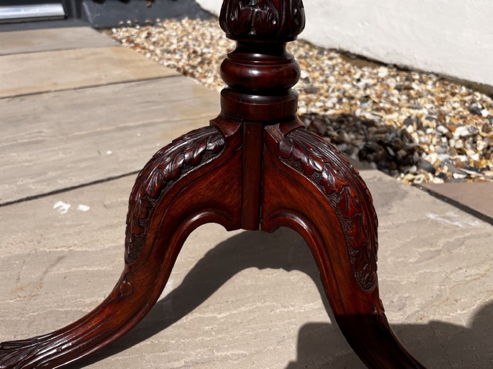 A 19th-century mahogany tripod occasional table featuring a circular polished top, turned central stem, and three carved cabriole legs. View IV