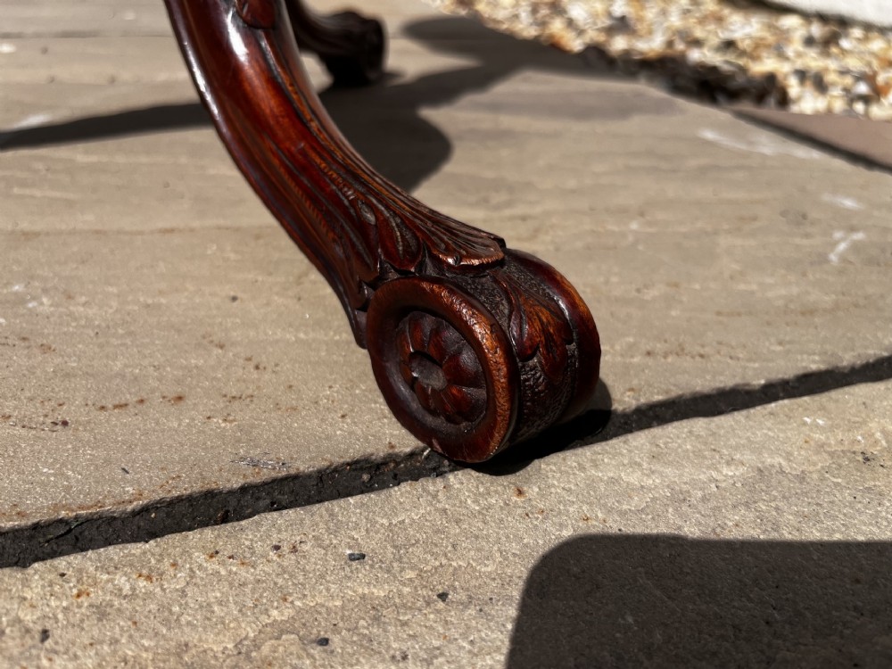 A 19th-century mahogany tripod occasional table featuring a circular polished top, turned central stem, and three carved cabriole legs. View V