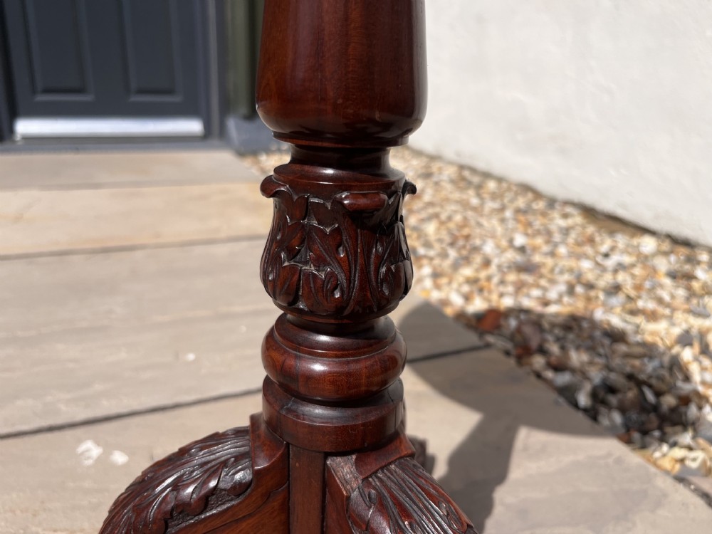 A 19th-century mahogany tripod occasional table featuring a circular polished top, turned central stem, and three carved cabriole legs. View VI