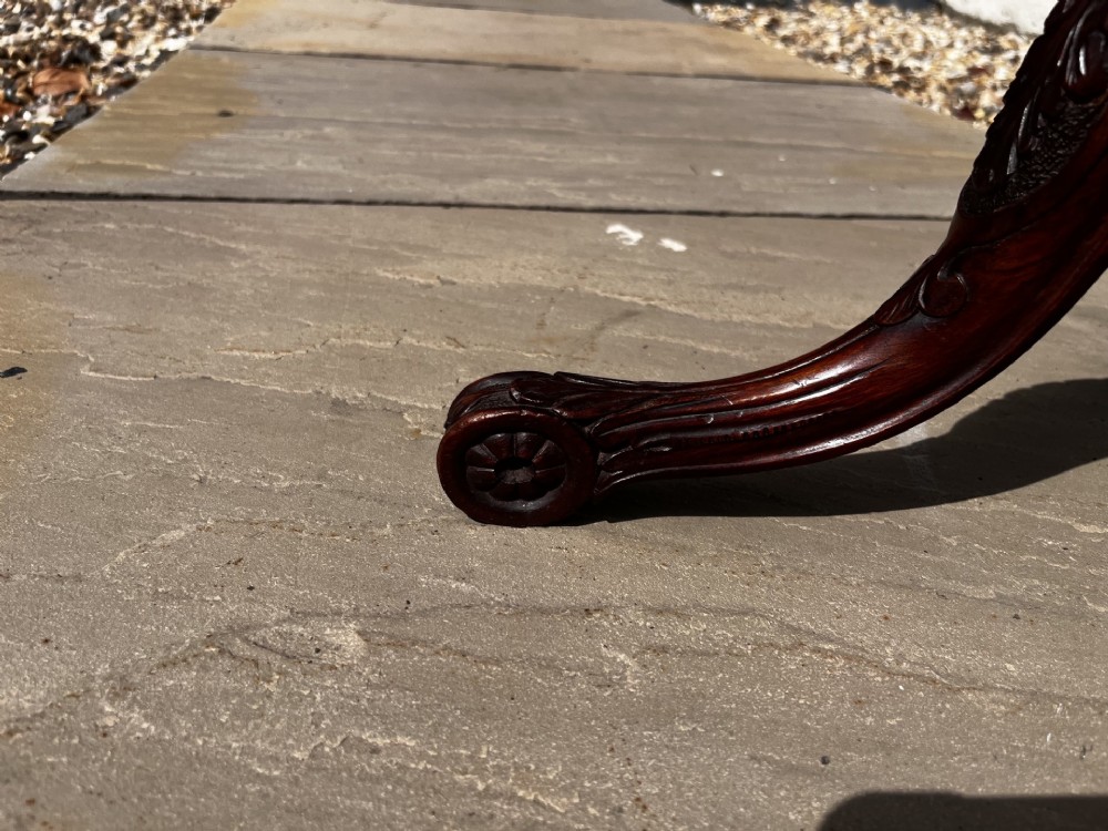 A 19th-century mahogany tripod occasional table featuring a circular polished top, turned central stem, and three carved cabriole legs. View VII