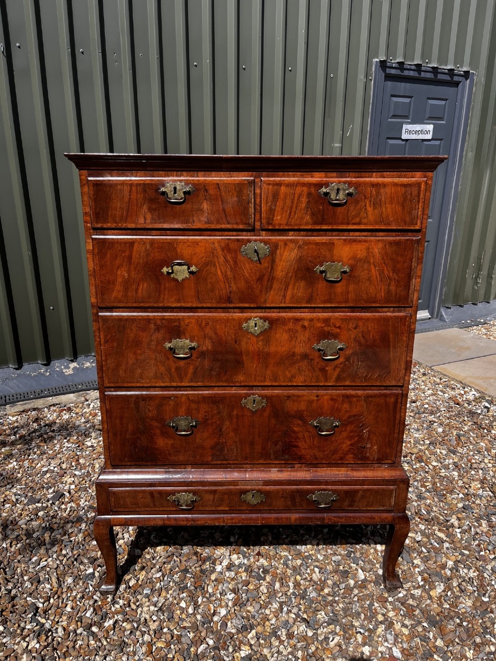 An 18th-century George II walnut chest on stand with brass handles, keyhole escutcheons, and cabriole legs. View II