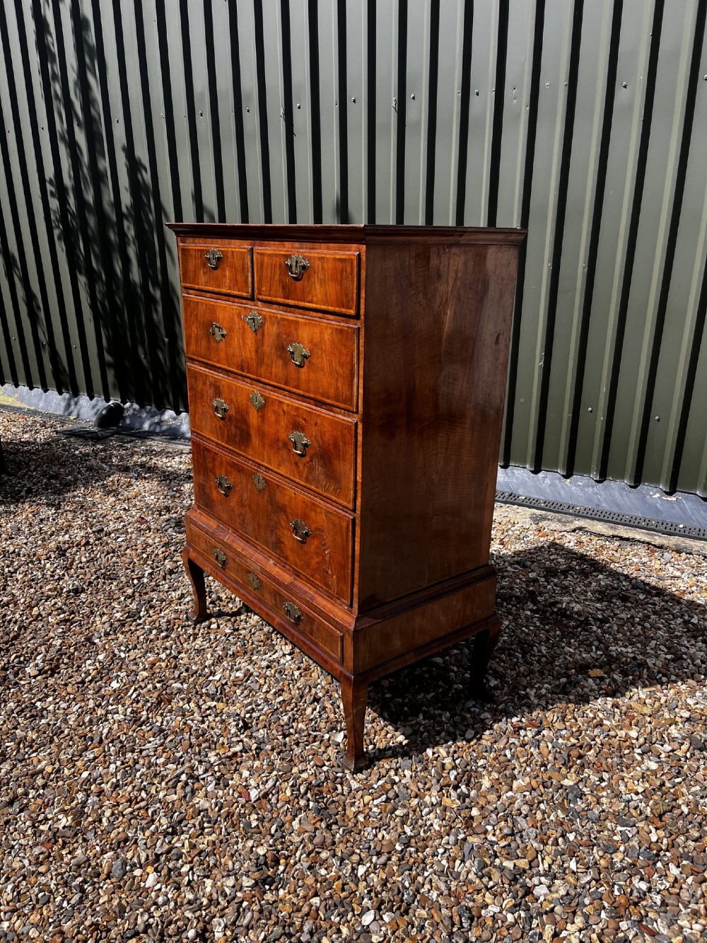 An 18th-century George II walnut chest on stand with brass handles, keyhole escutcheons, and cabriole legs. View III