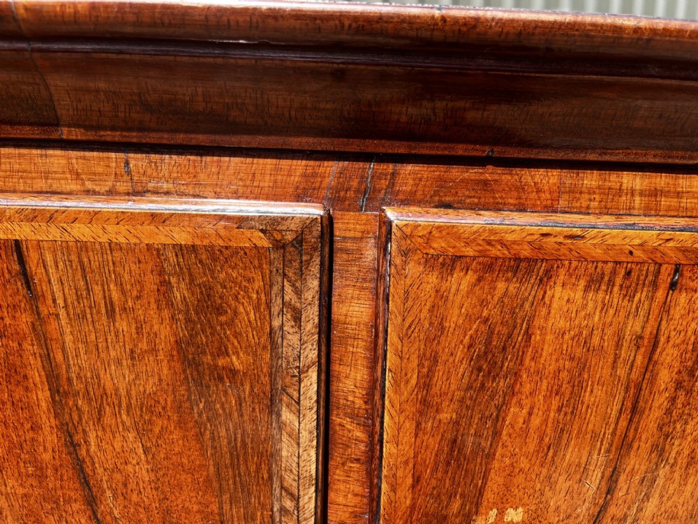 An 18th-century George II walnut chest on stand with brass handles, keyhole escutcheons, and cabriole legs. View V