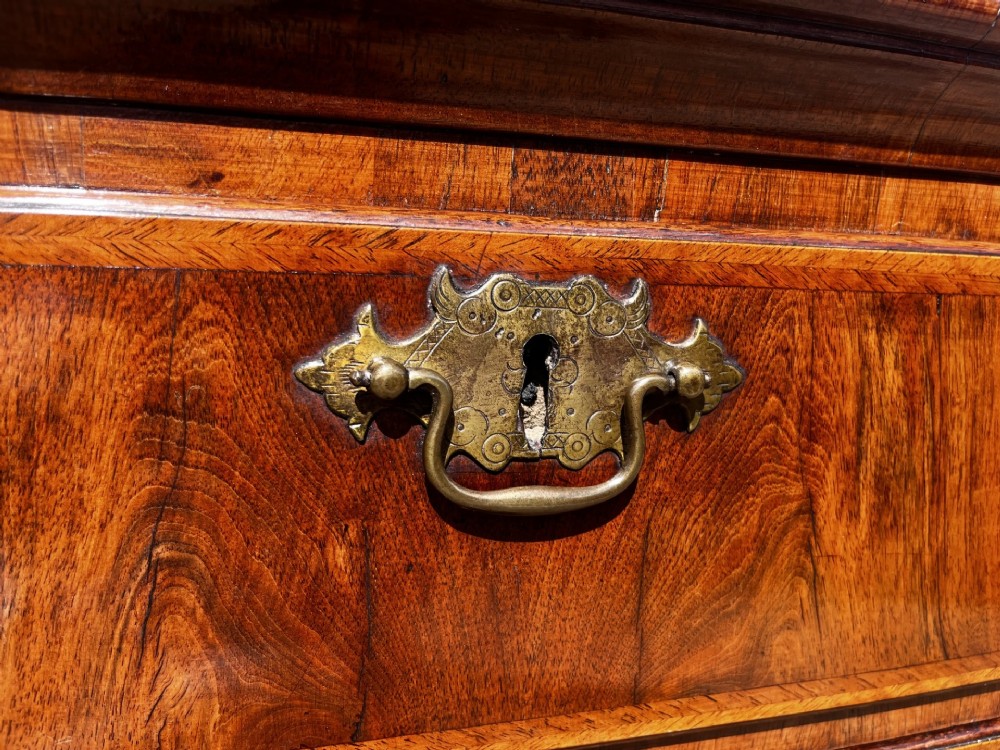 An 18th-century George II walnut chest on stand with brass handles, keyhole escutcheons, and cabriole legs. View VI