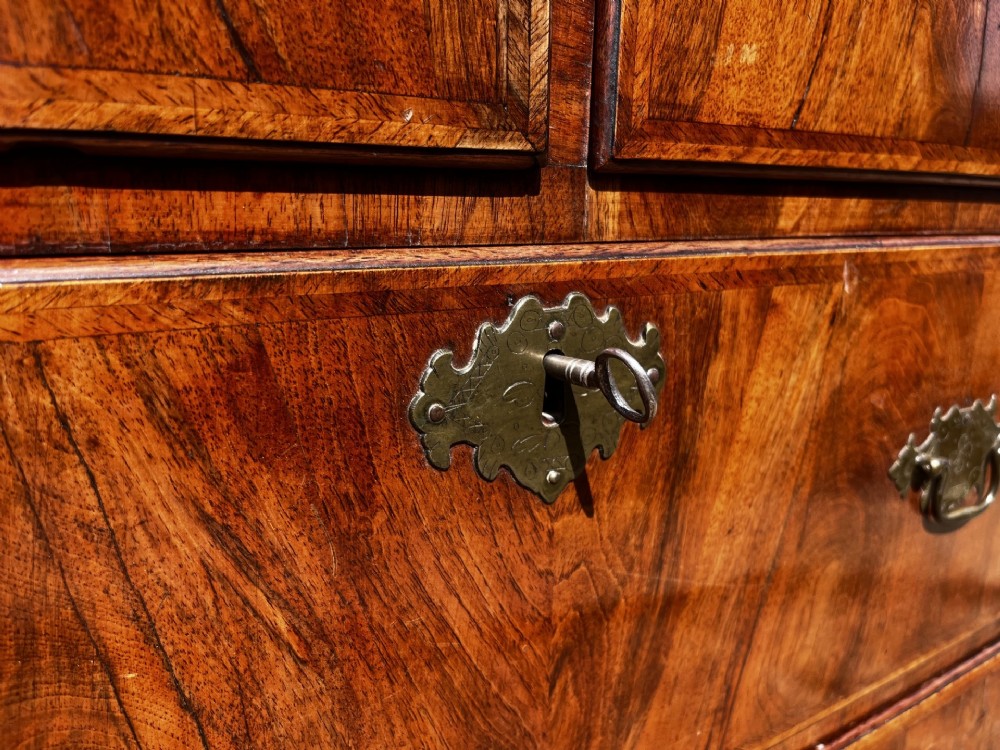 An 18th-century George II walnut chest on stand with brass handles, keyhole escutcheons, and cabriole legs. View VII