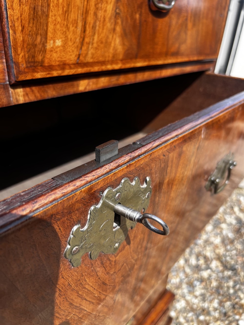 An 18th-century George II walnut chest on stand with brass handles, keyhole escutcheons, and cabriole legs. View VIII