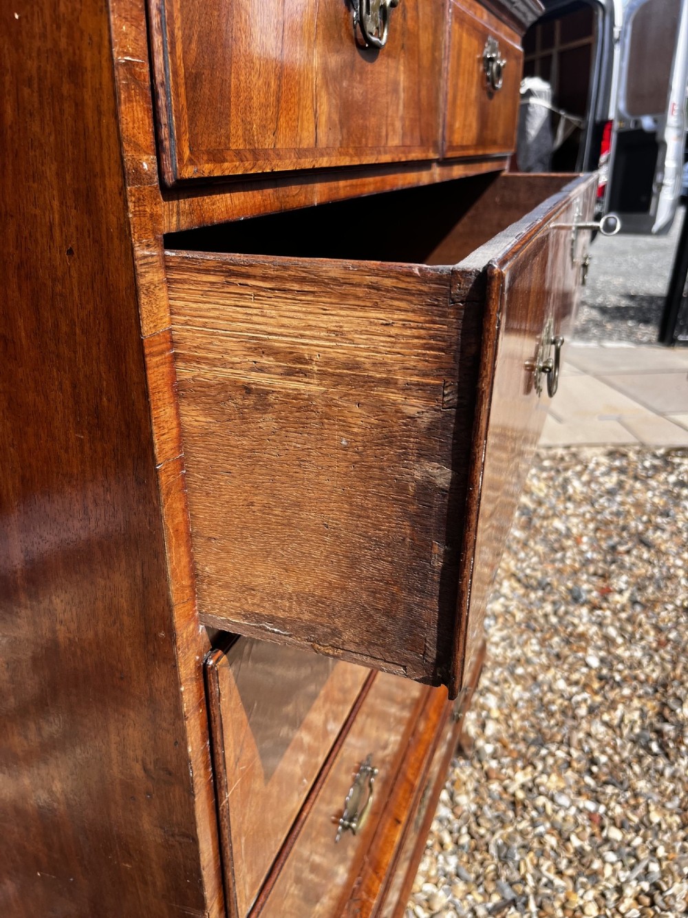 An 18th-century George II walnut chest on stand with brass handles, keyhole escutcheons, and cabriole legs. View IX