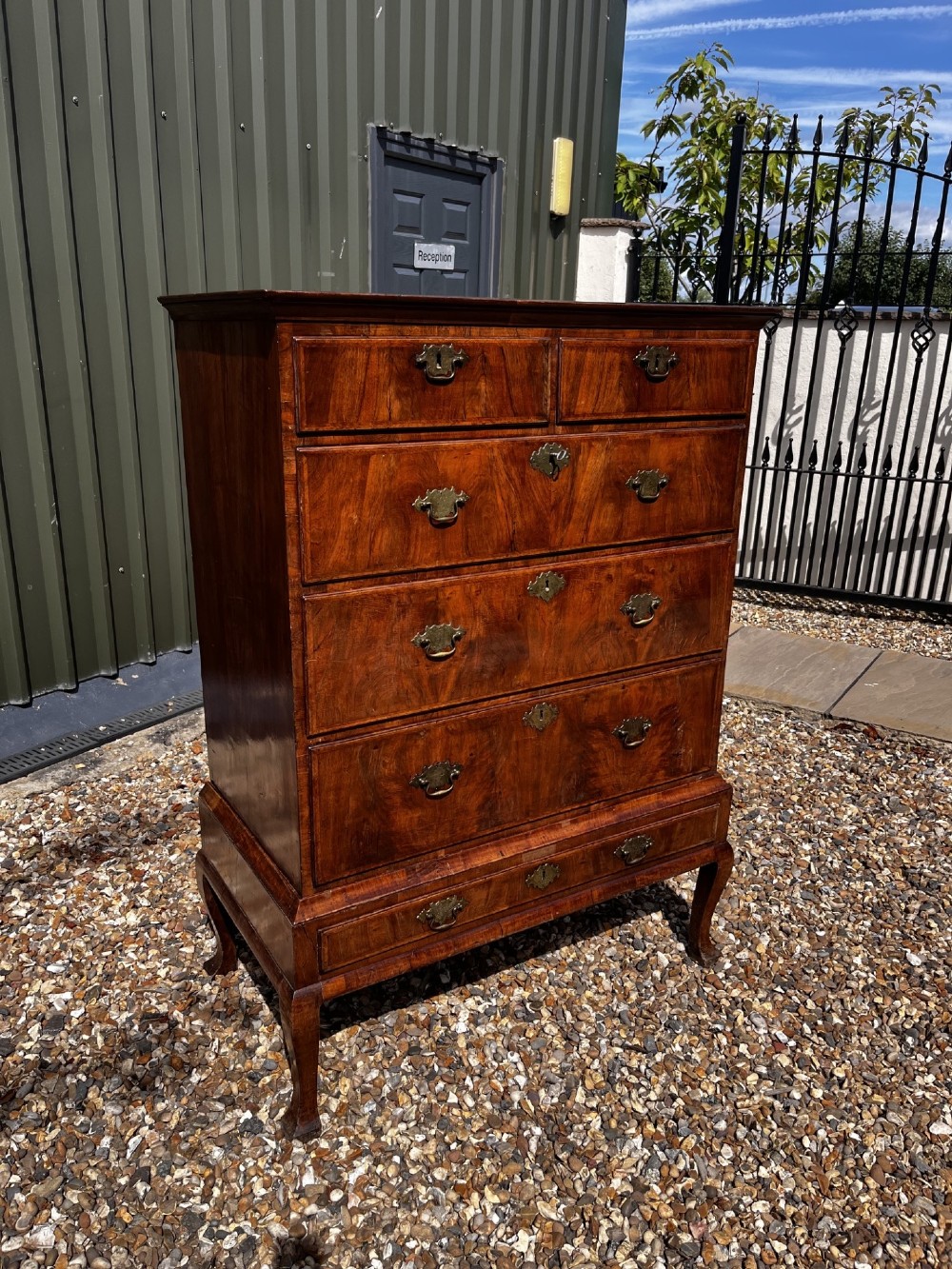An 18th-century George II walnut chest on stand with brass handles, keyhole escutcheons, and cabriole legs. View XI