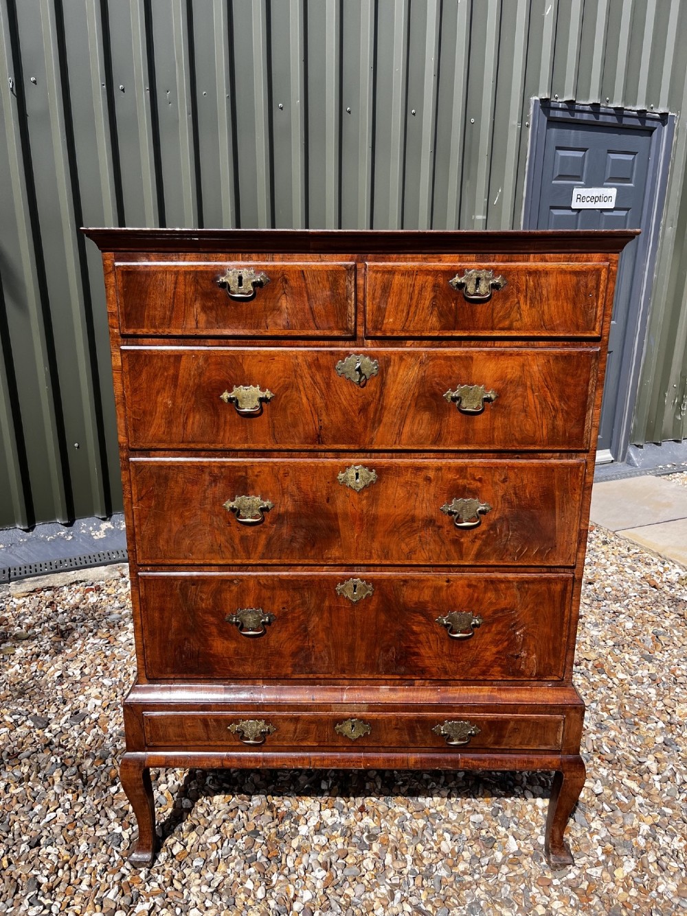 An 18th-century George II walnut chest on stand with brass handles, keyhole escutcheons, and cabriole legs. View XII