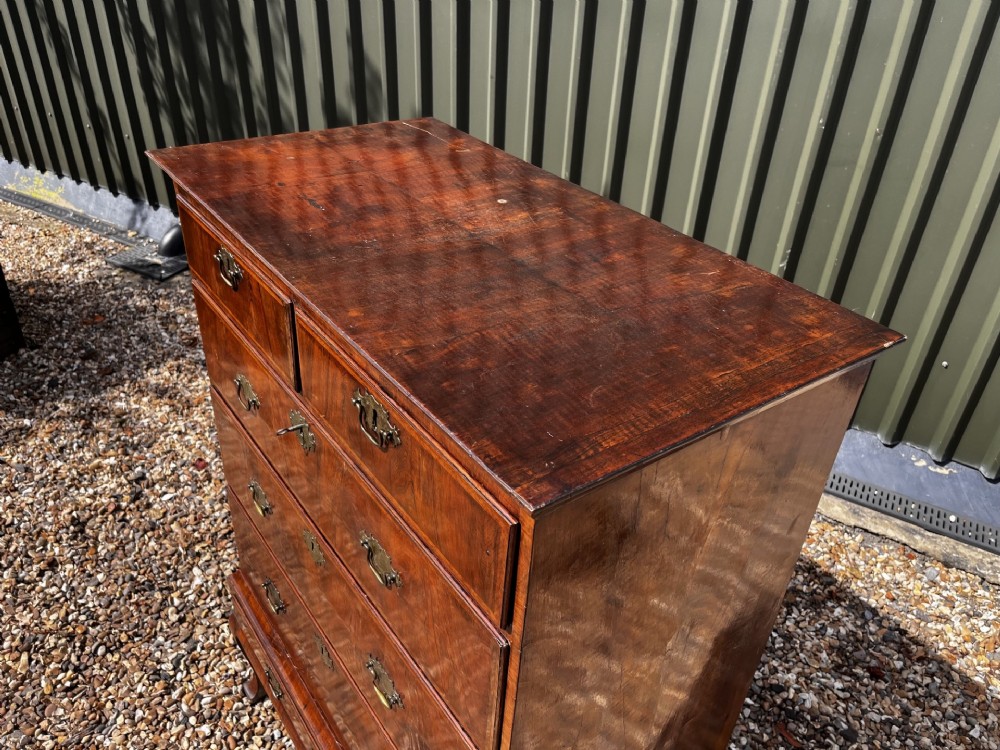An 18th-century George II walnut chest on stand with brass handles, keyhole escutcheons, and cabriole legs. View XIII
