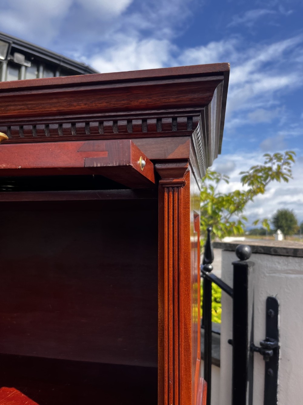 A four-tier solid mahogany barrister stacking bookcase featuring glazed up-and-over doors with brass knobs and a moulded top cornice. View VIII
