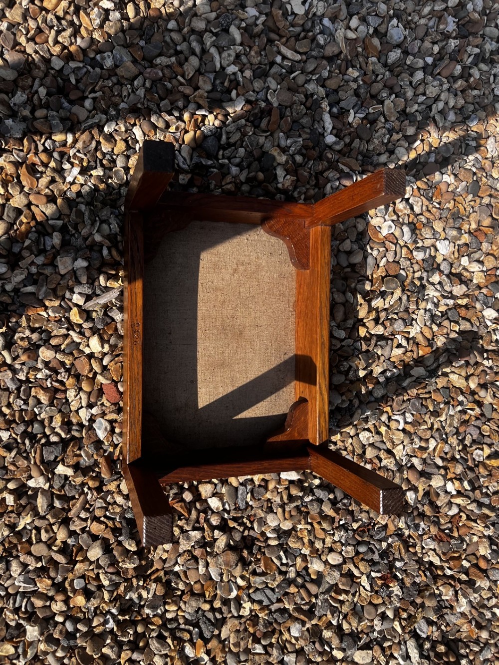 A rectangular Arts and Crafts oak stool featuring a brown leather top secured with a row of decorative metal studs around the rim. View VI