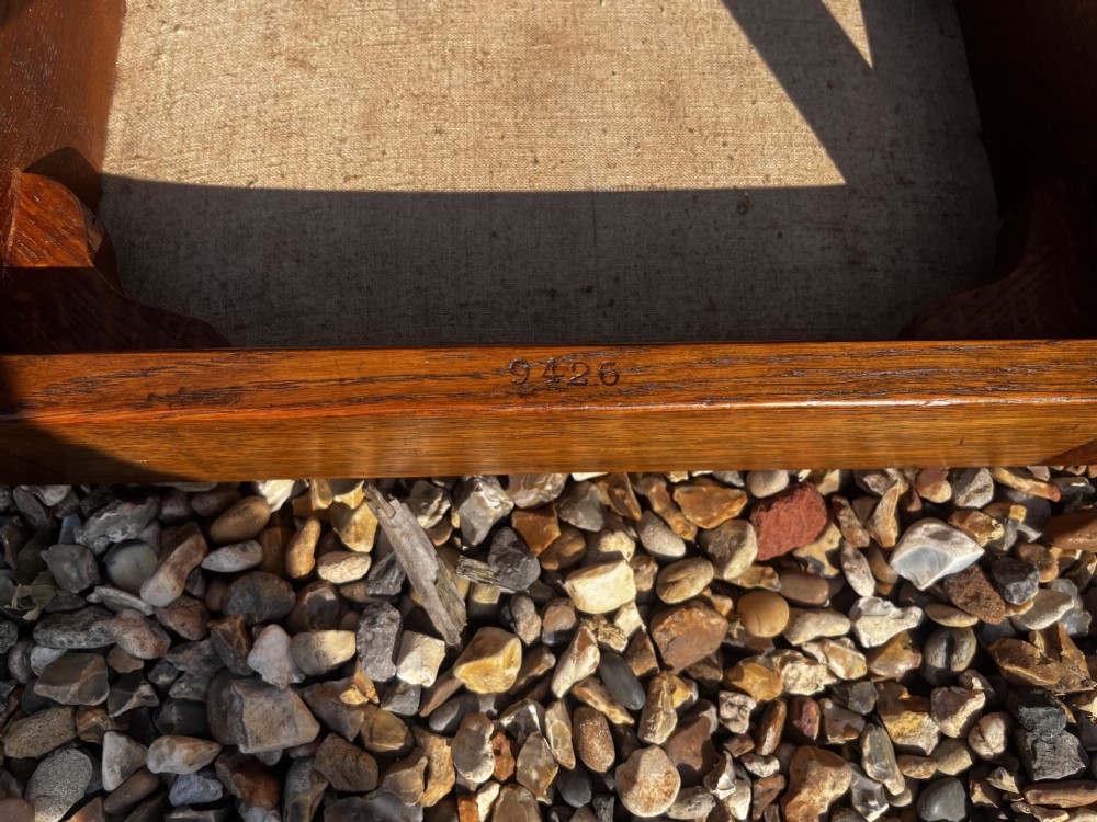 A rectangular Arts and Crafts oak stool featuring a brown leather top secured with a row of decorative metal studs around the rim. View VII