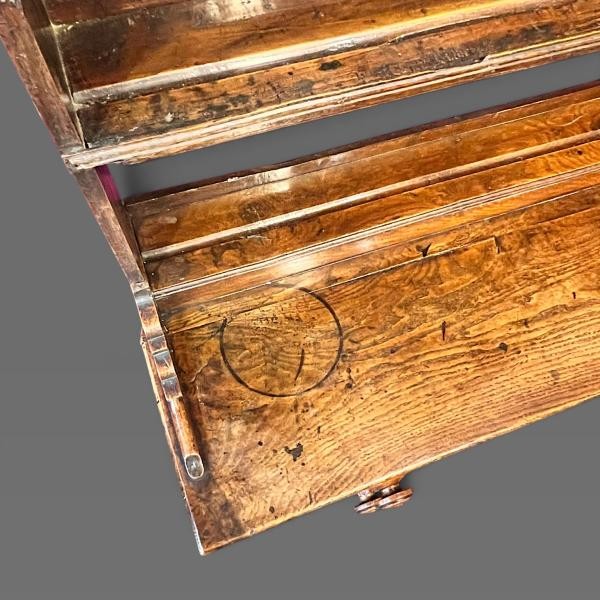 An early 19th-century dark oak Welsh dresser featuring a tall three-shelf open plate rack mounted on a base with five drawers, turned legs, and a lower pot board shelf. View V