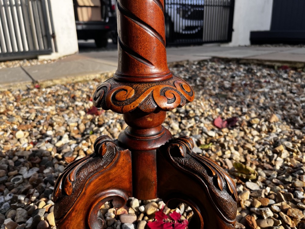 A Victorian burr walnut wine table featuring a scalloped top with floral marquetry inlay, a carved central pedestal, and tripod legs. View II