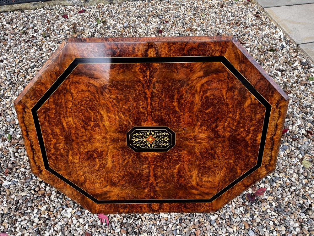 An octagonal Victorian burr walnut low coffee table with central floral marquetry inlay and splayed legs. View VIII