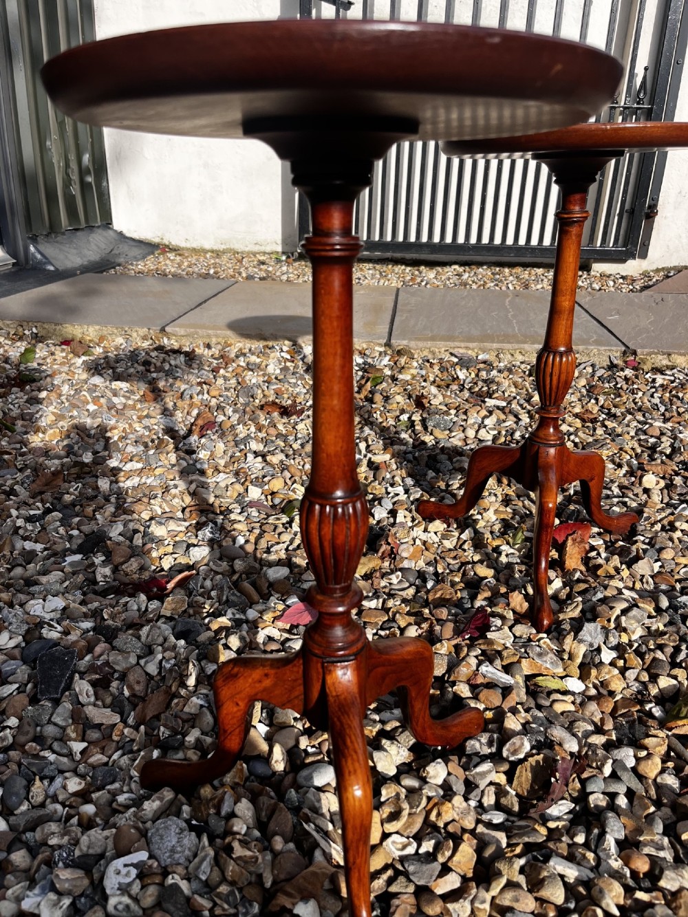 A pair of Edwardian mahogany wine tables featuring circular inlaid tops, turned stems, and tripod legs. View IV