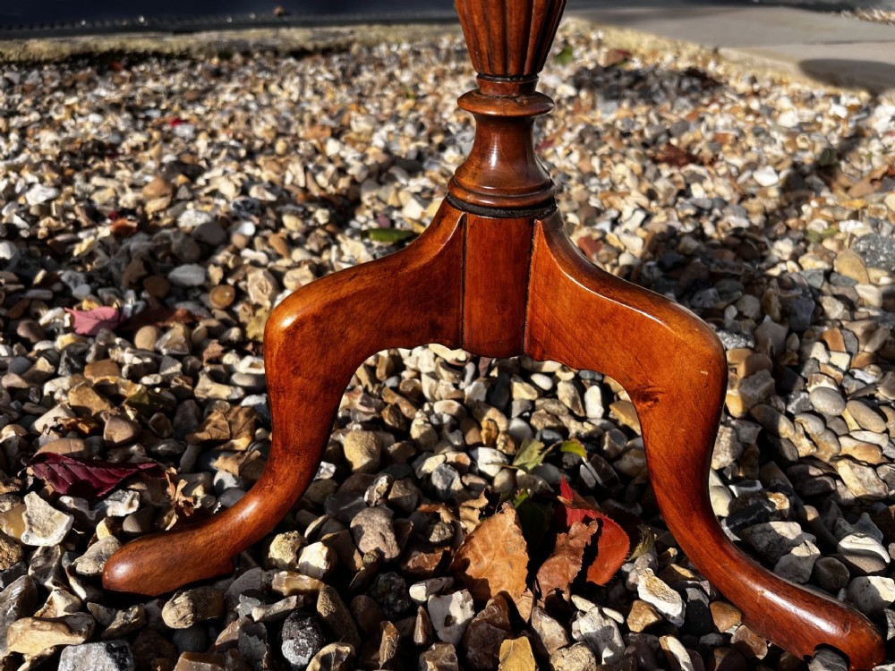 A pair of Edwardian mahogany wine tables featuring circular inlaid tops, turned stems, and tripod legs. View V