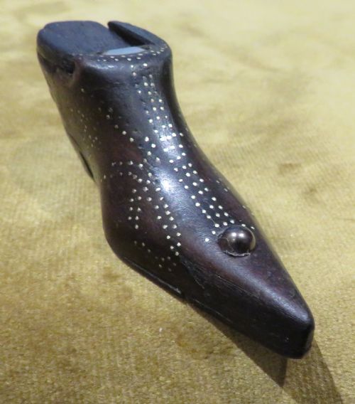 fig 1. A late Georgian carved dark wood shoe-shaped snuff box featuring decorative brass pique work pin patterns and a removable sliding wooden cover.