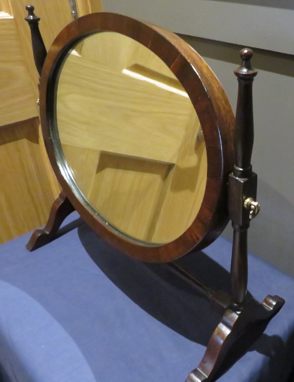 Victorian mahogany swing mirror featuring an oval frame held between two turned upright posts on trestle feet. View II