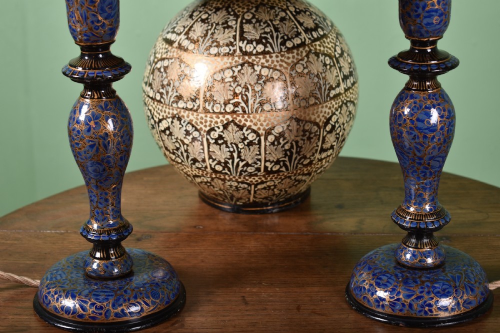 Three hand-painted Kashmiri table lamps consisting of two blue baluster stems and one central spherical patterned base, each topped with pleated lampshades. View II