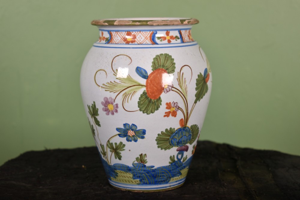 A white tin-glazed earthenware vase featuring hand-painted polychrome Garofano carnation motifs in orange, green, blue, and purple.