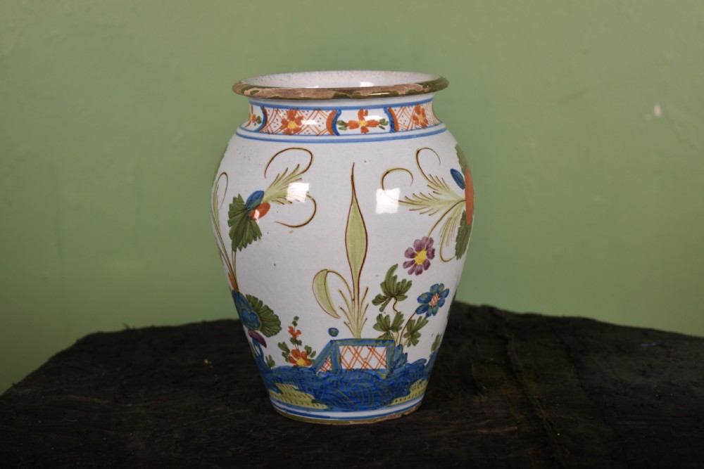 A white tin-glazed earthenware vase featuring hand-painted polychrome Garofano carnation motifs in orange, green, blue, and purple. View II