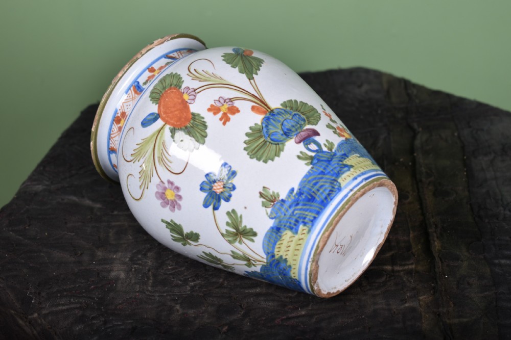A white tin-glazed earthenware vase featuring hand-painted polychrome Garofano carnation motifs in orange, green, blue, and purple. View IV