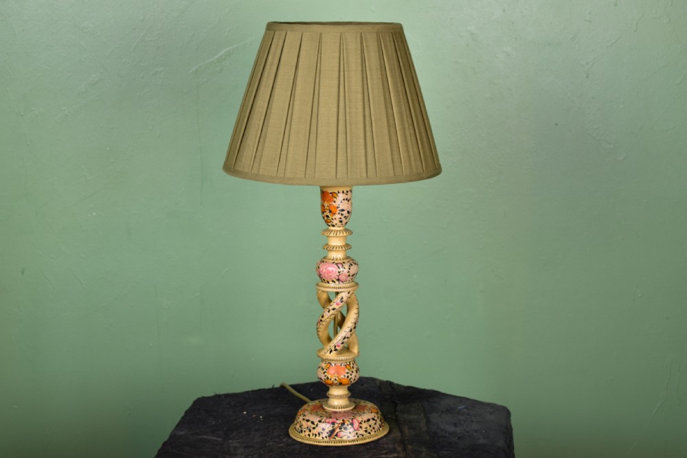 A Kashmiri hand-painted table lamp with an openwork twist floral column base and a pleated olive green shade.