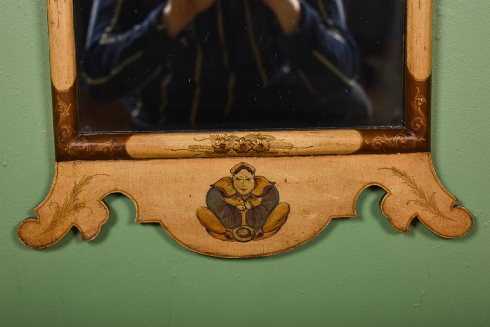 A tall, narrow cream painted wall mirror featuring a shaped scroll crest with a central shell motif and a hand-painted chinoiserie scene above the rectangular glass. View III