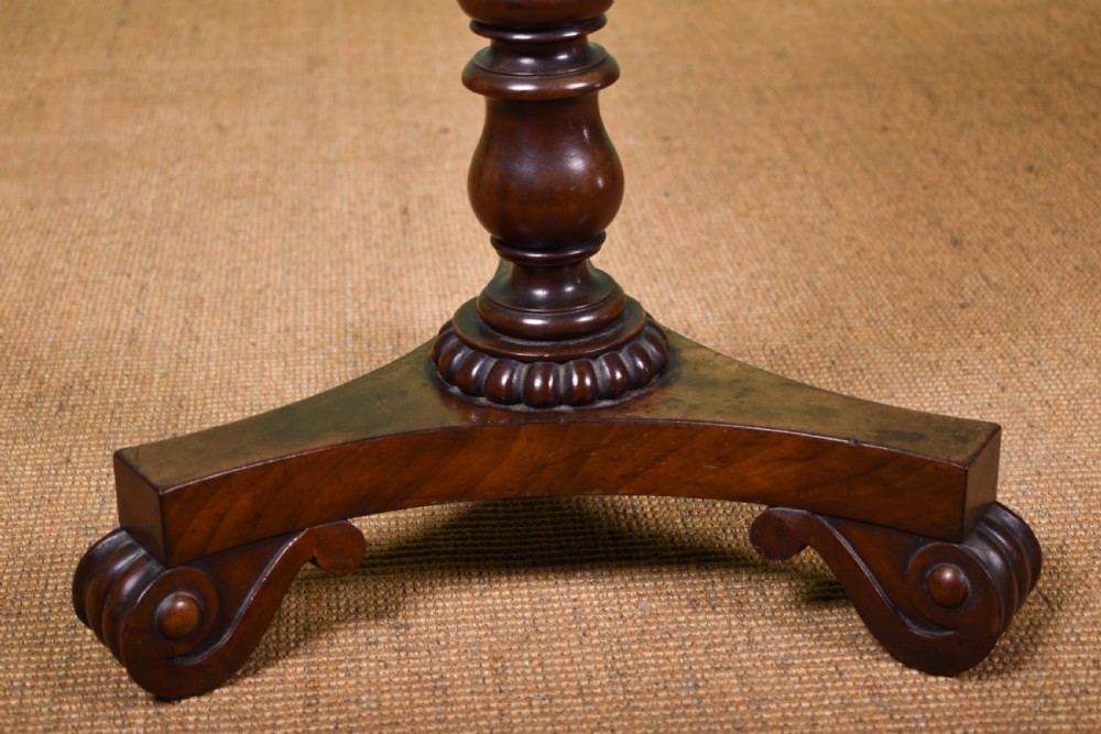 A William IV mahogany side table with a painted hexagonal top, spiral-carved central column, and a triform scroll-foot base. View II