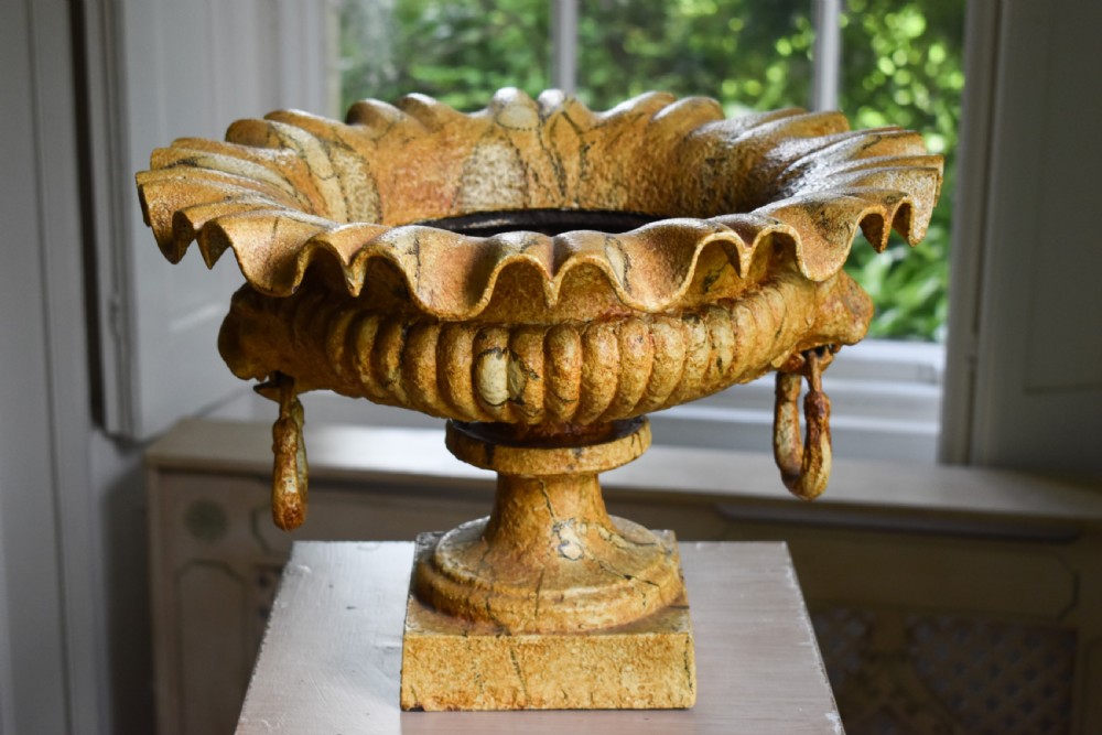 A pair of yellow painted cast iron urns with scalloped rims, gadrooned bodies, and square pedestal bases. View II