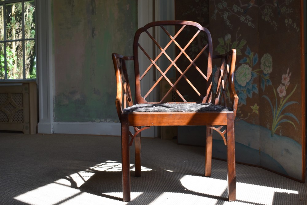A George III mahogany Cockpen armchair featuring a lattice fretwork backrest, open arms, and a patterned upholstered seat cushion. View IV