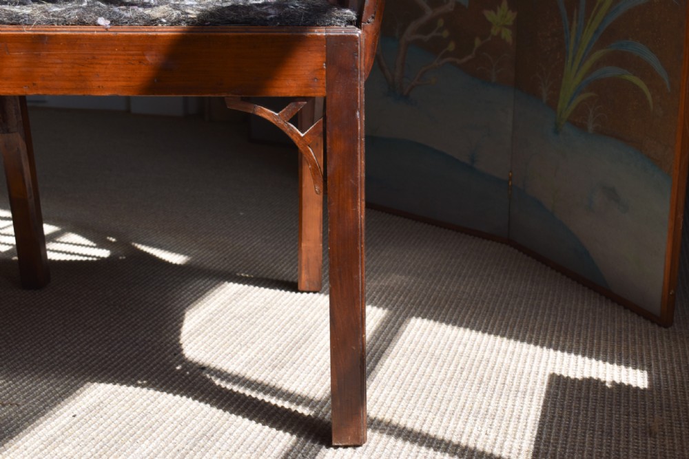 A George III mahogany Cockpen armchair featuring a lattice fretwork backrest, open arms, and a patterned upholstered seat cushion. View VI